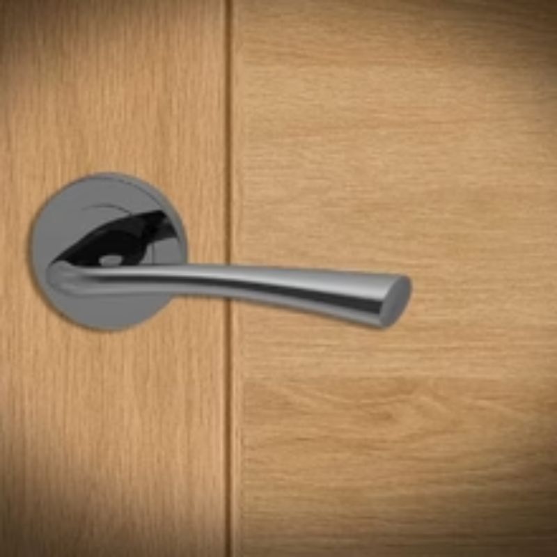 Chrome bathroom lever handle with round rose from XL Joinery, suitable for 65mm and 75mm doors.