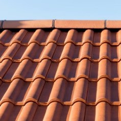 Terracotta roof tiles with a wavy design, perfect for residential roofing applications.