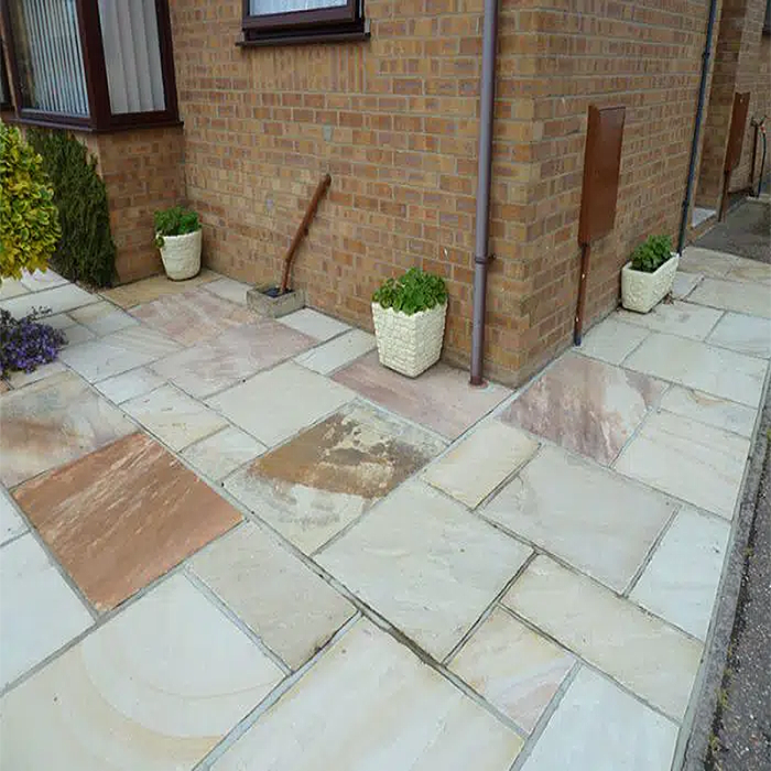Traditional mint fossil sandstone paving slabs in mixed pack, ideal for patios, featuring a textured finish by Paveworld.