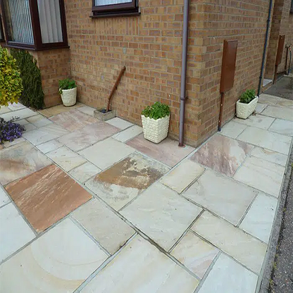 Traditional mint fossil sandstone paving slabs in mixed pack, ideal for patios, featuring a textured finish by Paveworld.