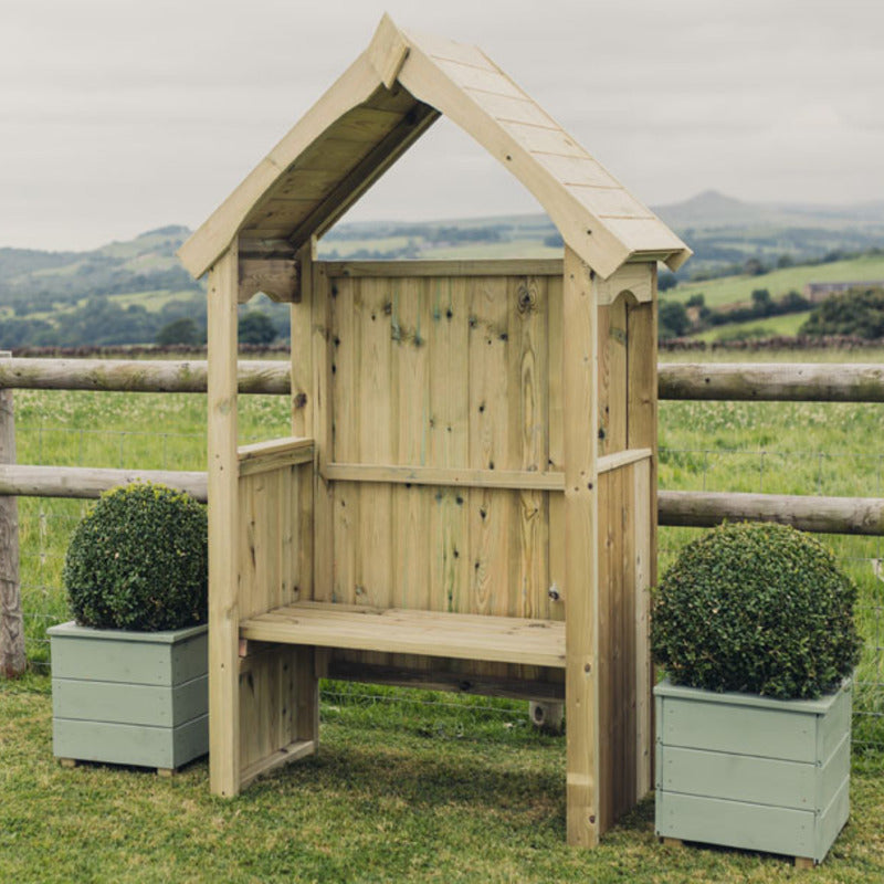 Churnet Valley wooden poppy arbour with pitched roof, featuring bench seating and surrounding planters.