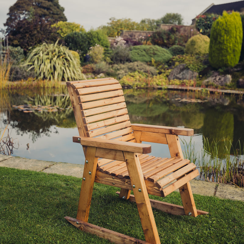 Churnet Valley wooden rocking chair with slatted design, perfect for outdoor gardens.