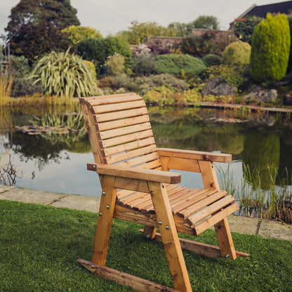 Churnet Valley wooden rocking chair with slatted design, perfect for outdoor gardens.