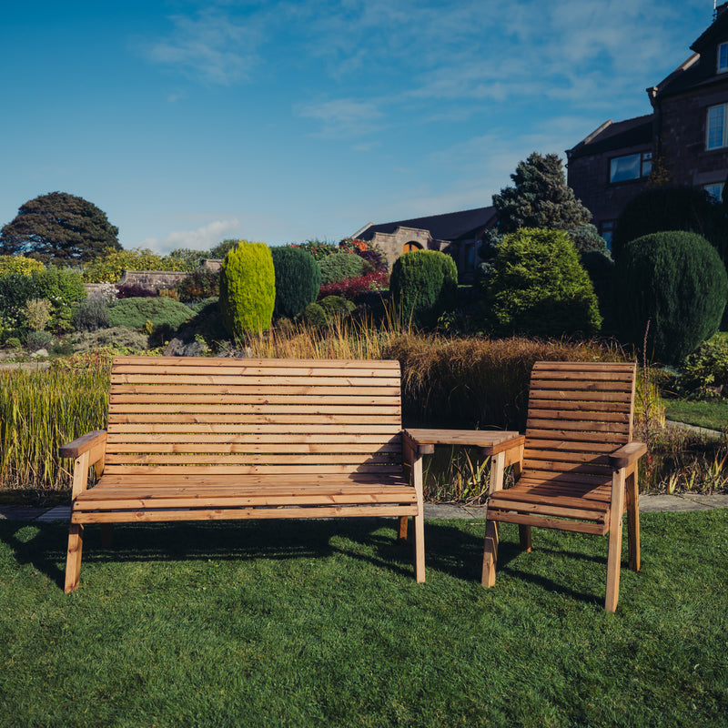 Churnet Valley wooden garden furniture set with one chair, three-seat bench, and angled tray on a grassy lawn.