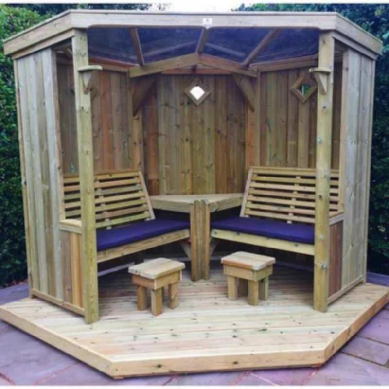 Churnet Valley wooden garden room with decking, featuring built-in benches and a hexagonal design.