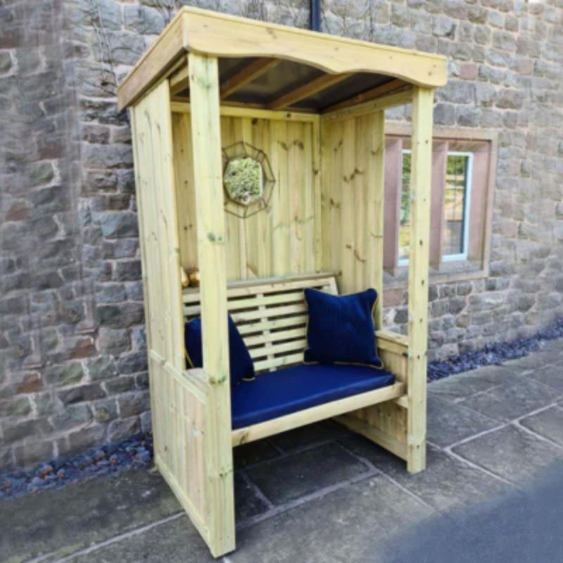 Natural wood two-seat arbour with a slatted back and navy cushions by Churnet Valley