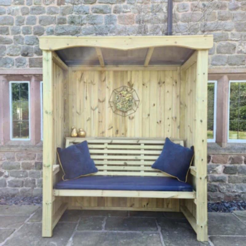 Churnet Valley wooden 3-seat arbour with slatted back, blue cushions, and canopy top, perfect for outdoor relaxation.