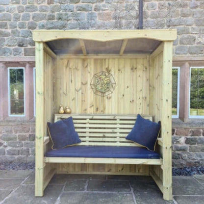 Churnet Valley wooden 3-seat arbour with slatted back, blue cushions, and canopy top, perfect for outdoor relaxation.