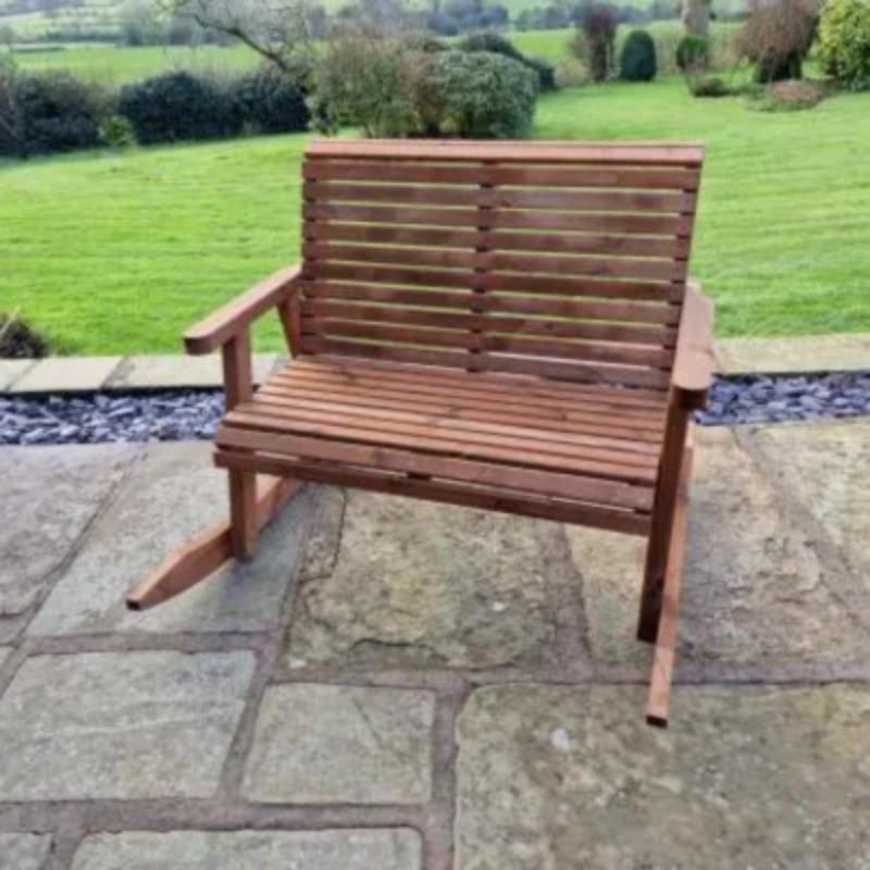 Churnet Valley wooden rocking bench with slatted design, perfect for outdoor garden spaces.
